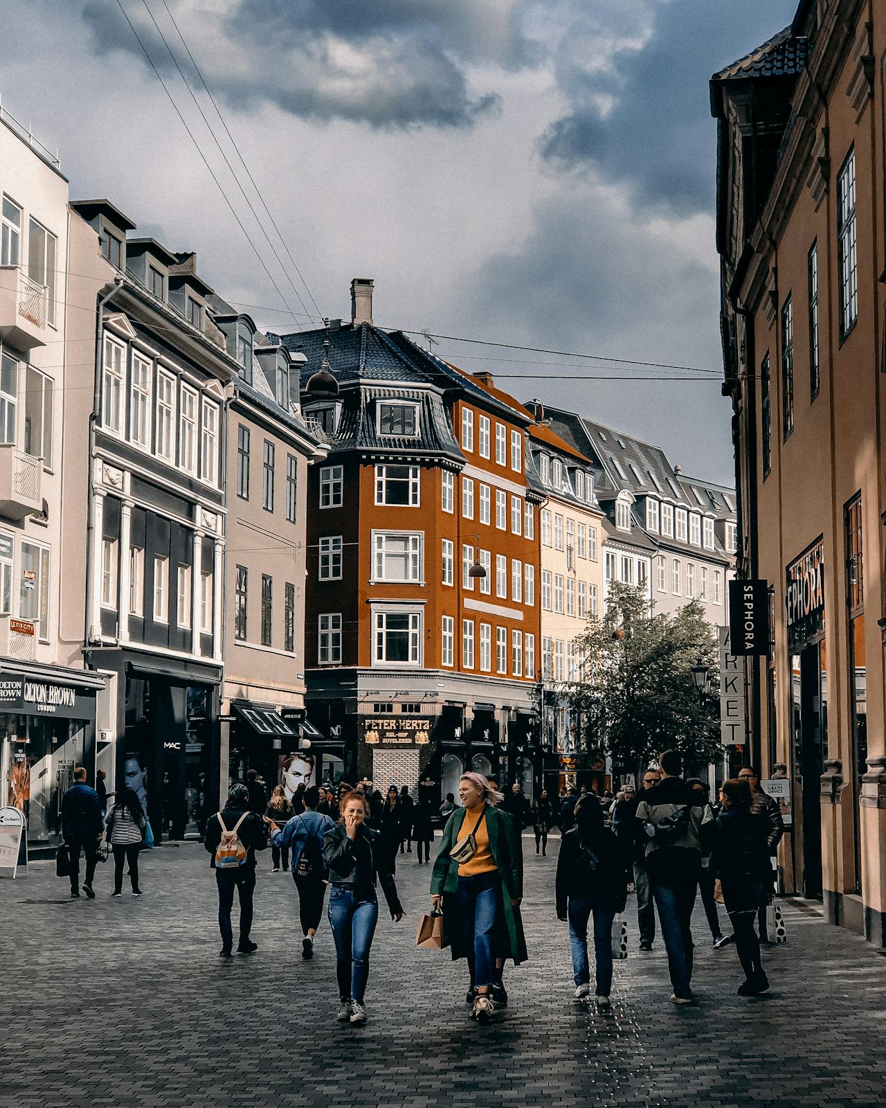 People walking on a street in Copenhagen city — exploring the city on foot.